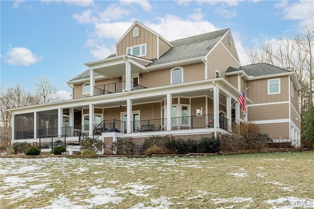 view of front of house featuring a balcony and a lawn