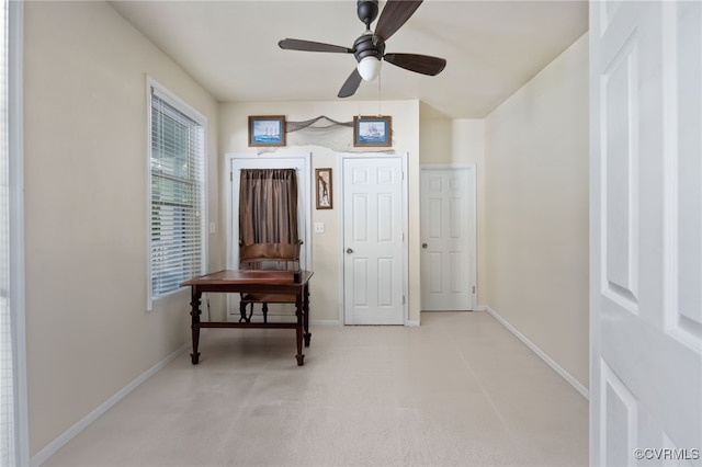 interior space featuring light carpet and ceiling fan