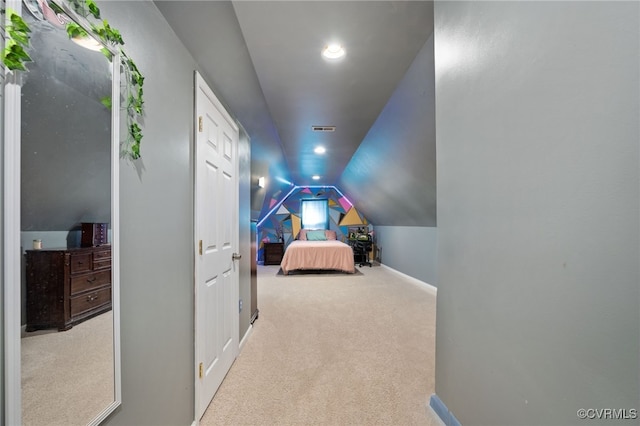 bedroom featuring light carpet and lofted ceiling