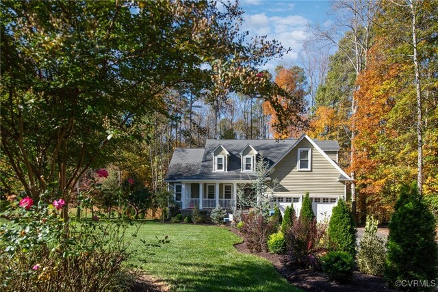 new england style home with covered porch and a front lawn