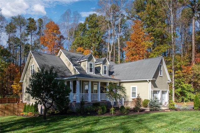 cape cod-style house featuring a garage, a front lawn, and a porch