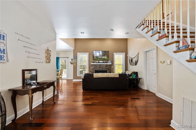 living room featuring a fireplace and dark hardwood / wood-style flooring