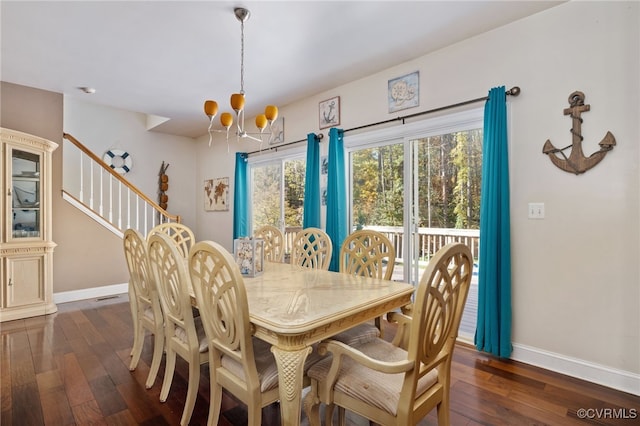 dining space featuring an inviting chandelier and dark wood-type flooring