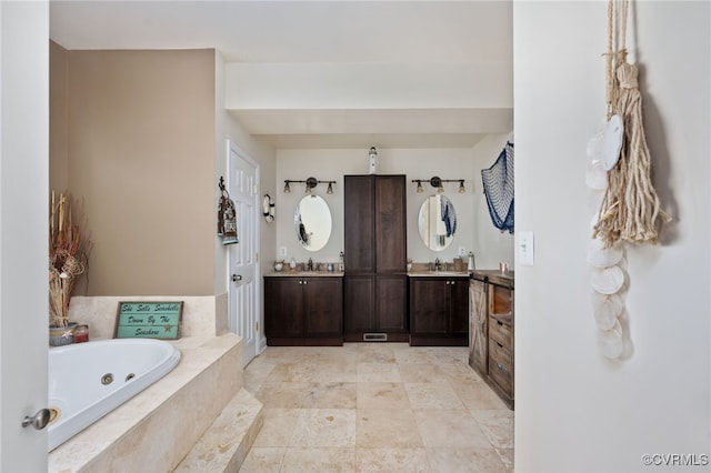 bathroom with tiled bath and vanity