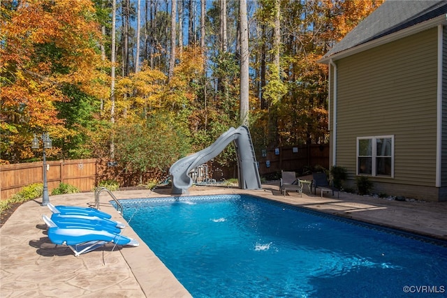 view of pool featuring a patio area and a water slide