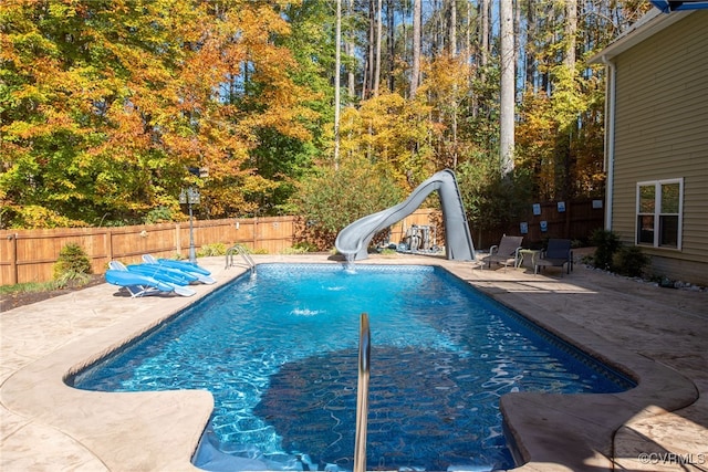 view of pool with a patio area and a water slide