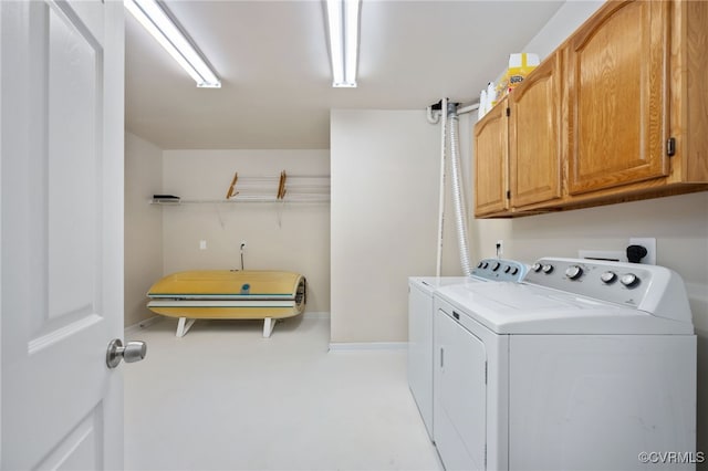 laundry area with cabinets and independent washer and dryer