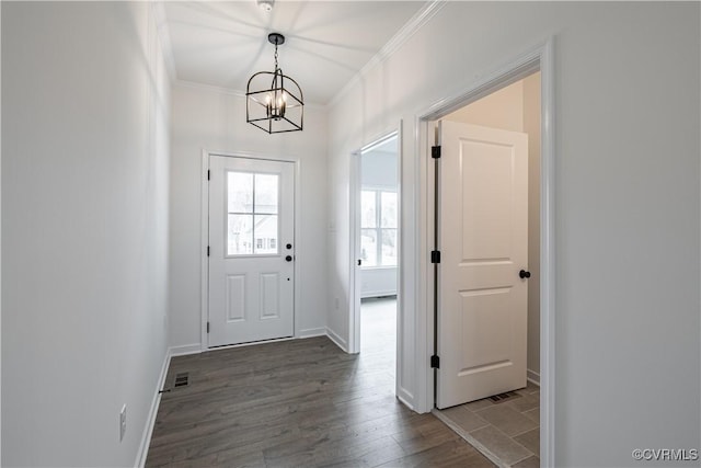 doorway featuring crown molding, wood-type flooring, and an inviting chandelier