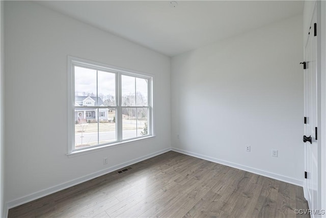 spare room with hardwood / wood-style flooring