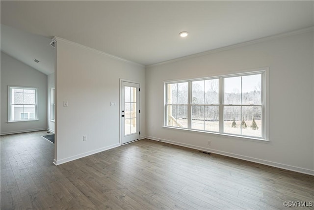 unfurnished room with crown molding, wood-type flooring, and vaulted ceiling