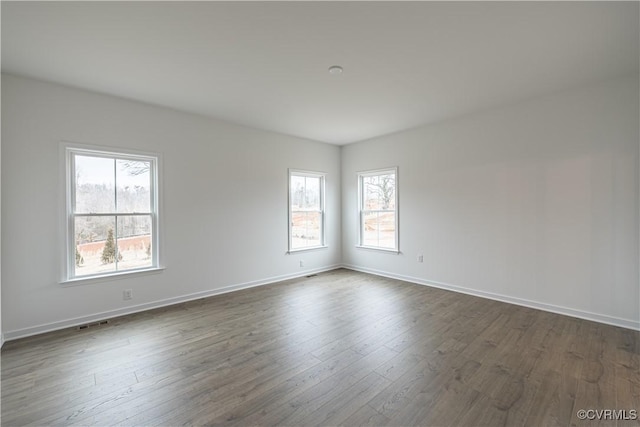 unfurnished room with dark hardwood / wood-style flooring