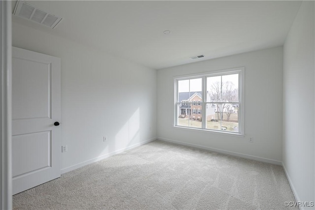 spare room with light colored carpet