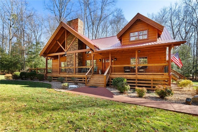 cabin featuring a front yard and covered porch