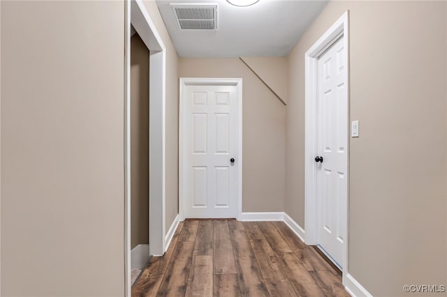 corridor featuring dark wood-type flooring