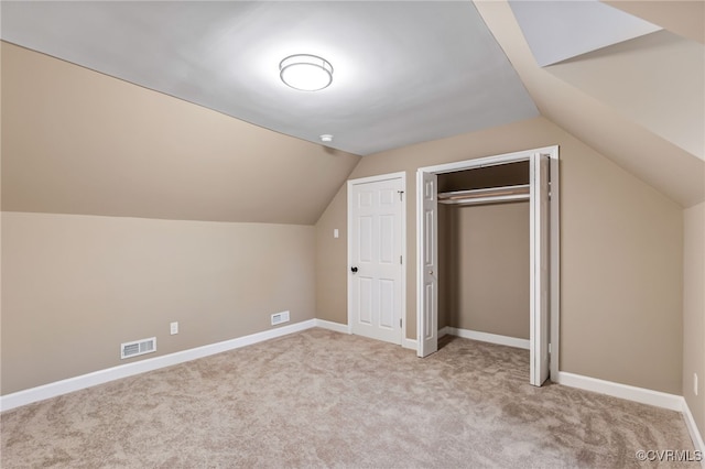 additional living space with light carpet and lofted ceiling