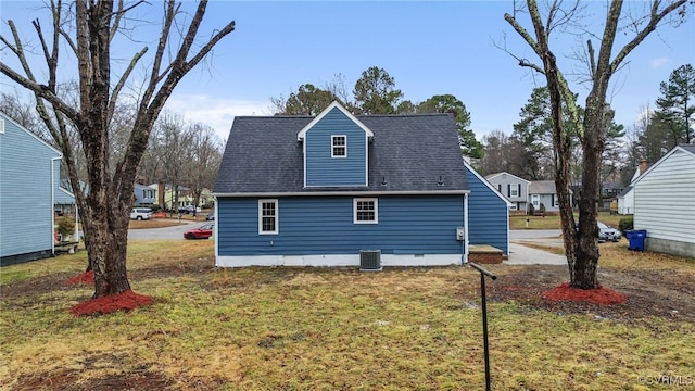 view of side of home featuring central AC unit and a yard