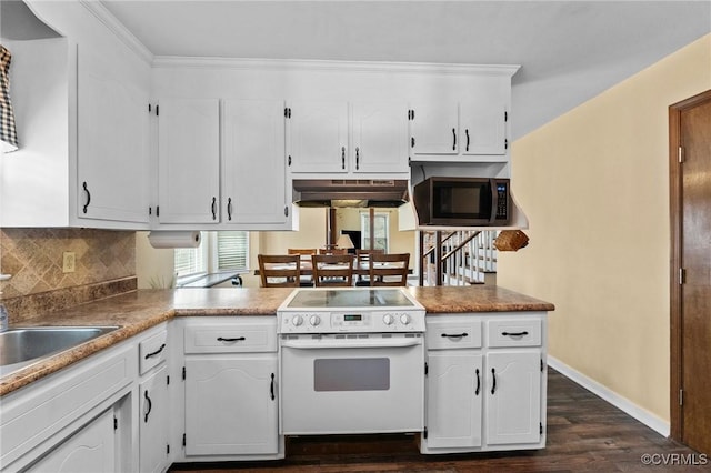 kitchen with electric range, decorative backsplash, dark hardwood / wood-style floors, and white cabinets