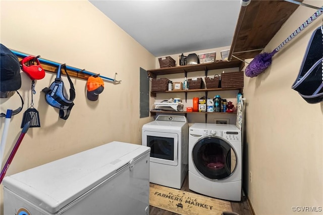 laundry room with hardwood / wood-style floors and independent washer and dryer