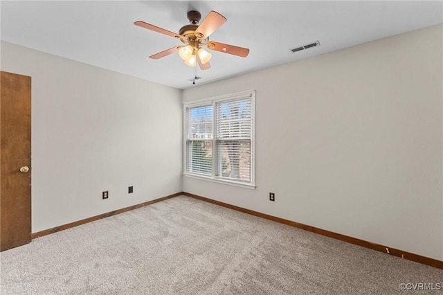 carpeted empty room featuring ceiling fan