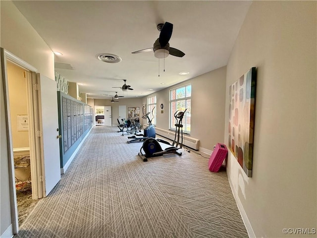 workout area with mail area, visible vents, carpet floors, a baseboard radiator, and baseboards