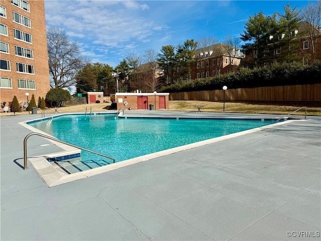 pool featuring a patio area and fence