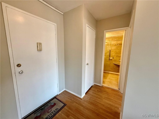 interior space with baseboards and wood finished floors