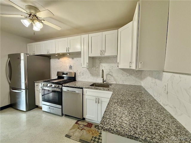 kitchen with a sink, appliances with stainless steel finishes, ceiling fan, and white cabinetry