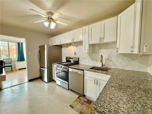 kitchen with white cabinets, appliances with stainless steel finishes, and a sink