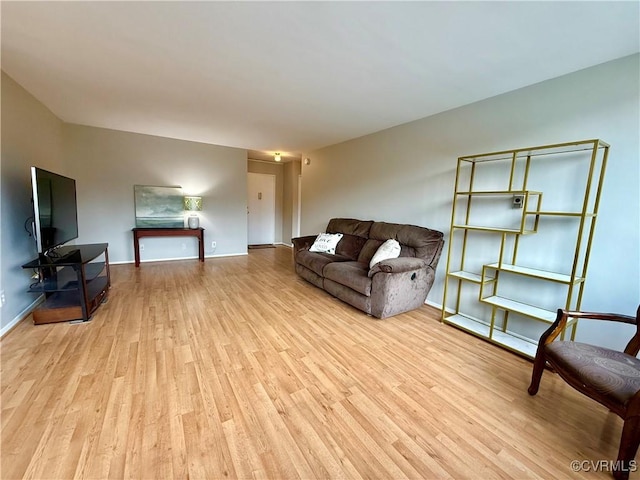 living area featuring baseboards and wood finished floors