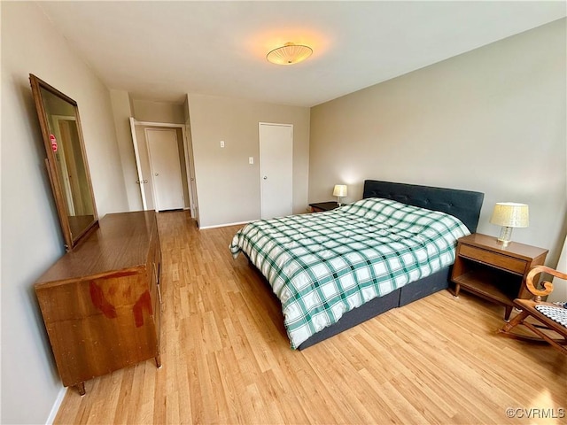 bedroom featuring light wood-style flooring and baseboards