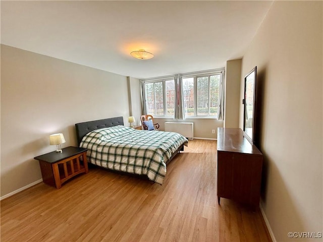 bedroom with baseboards and light wood-style floors