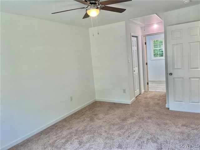 unfurnished room featuring ceiling fan and light carpet