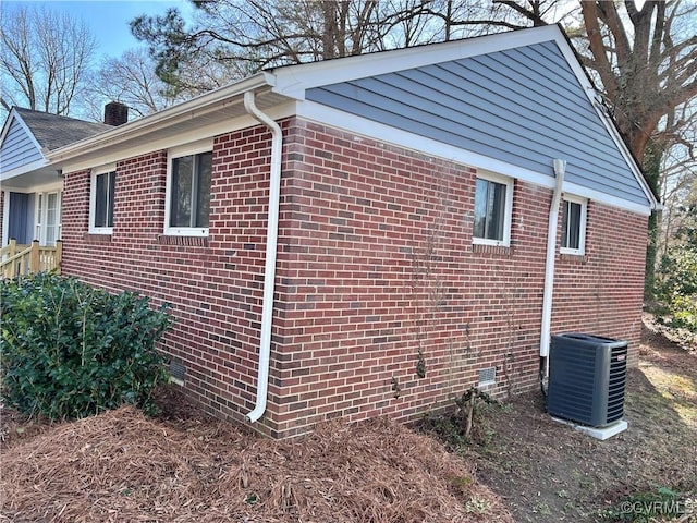 view of side of home with central AC