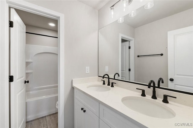 full bathroom featuring shower / tub combination, vanity, wood-type flooring, and toilet