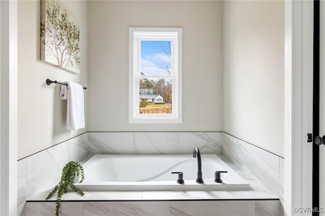 bathroom with tiled bath