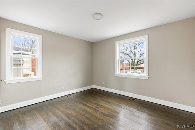 spare room featuring dark hardwood / wood-style flooring