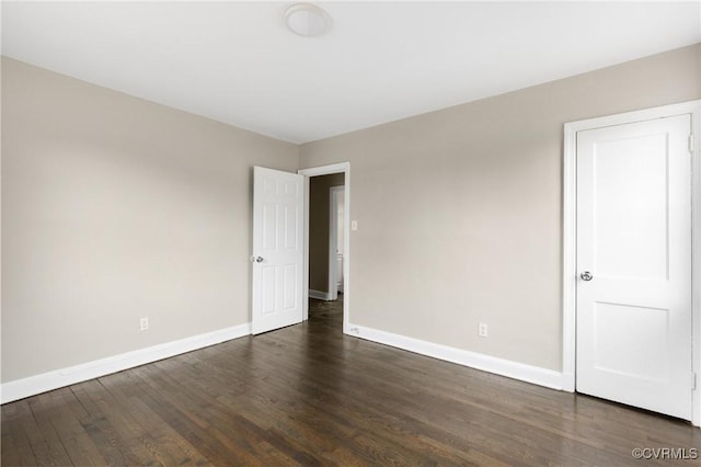 spare room with dark wood-type flooring