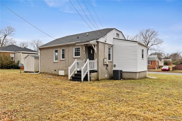 back of property featuring central AC, a storage unit, and a lawn