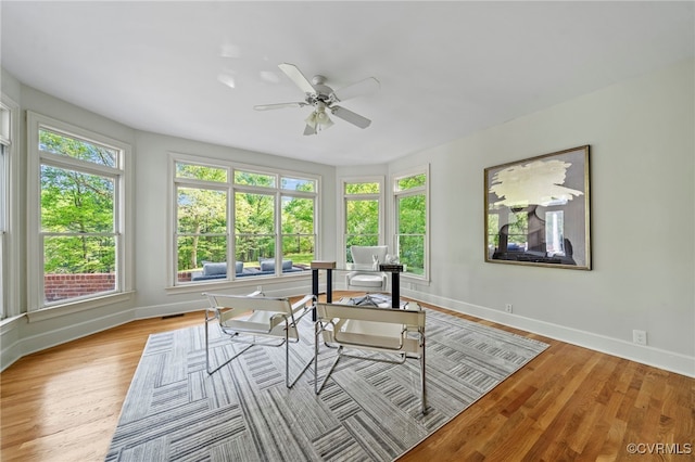 sunroom / solarium featuring visible vents and a ceiling fan