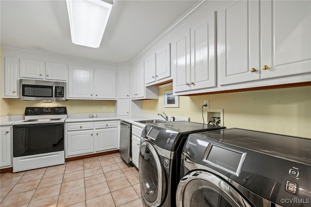 clothes washing area with washing machine and dryer, laundry area, light tile patterned flooring, and a sink