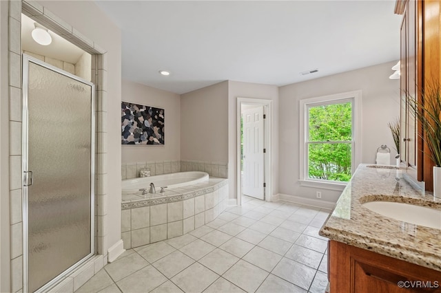 full bathroom featuring tile patterned flooring, visible vents, a garden tub, and a sink