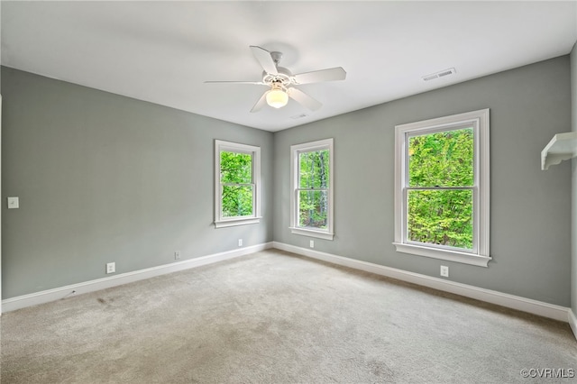 spare room with plenty of natural light, visible vents, and baseboards