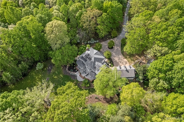 birds eye view of property with a view of trees