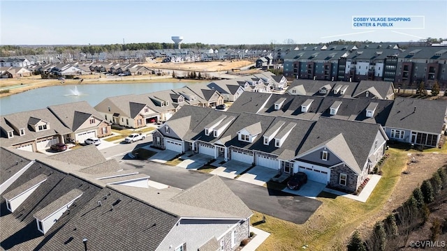 birds eye view of property featuring a water view and a residential view