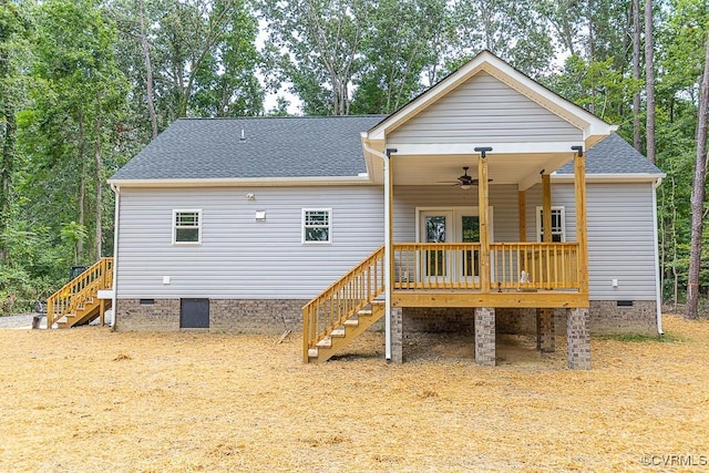 back of property with a deck and ceiling fan