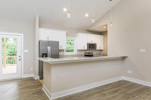 kitchen with pendant lighting, stainless steel appliances, and white cabinets