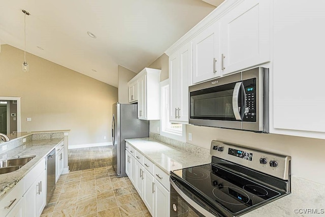 kitchen featuring lofted ceiling, sink, white cabinets, and appliances with stainless steel finishes