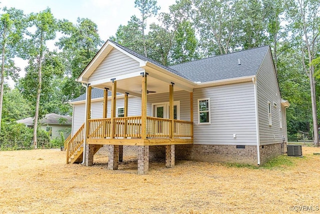 rear view of property featuring a deck and central air condition unit