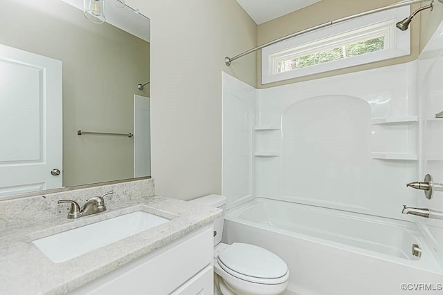 full bathroom featuring washtub / shower combination, vanity, and toilet