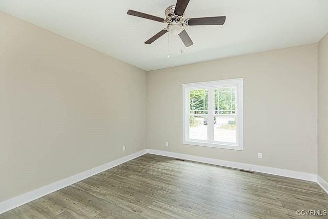 empty room with ceiling fan and hardwood / wood-style floors